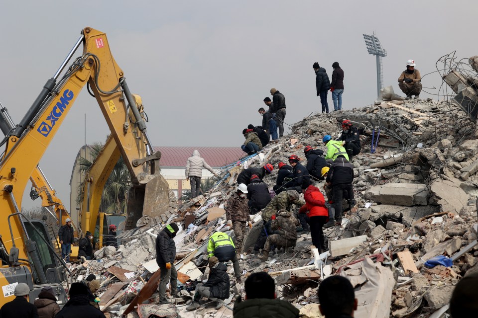 Workers at the site of destroyed buildings in Kahramanmara search through the rubble after the devastation in February