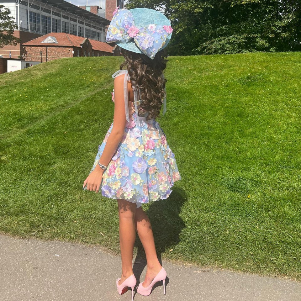 The teen donned a floral dress and pink stiletto heels