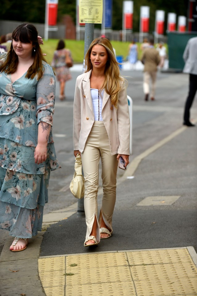 One guest donned a cream jacket, white corset top and beige trousers for the racing meet