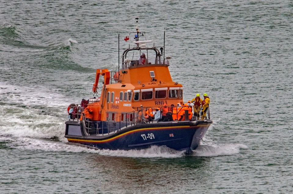 TikTok and Facebook are joining forces with Britain’s top crimebusters to crack down on people smugglers who lure migrants online - pictured RNLI rescuing migrants in the Channel