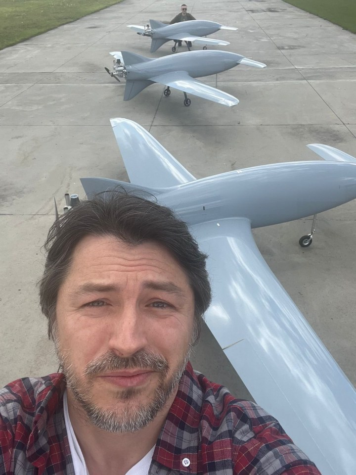 TV star Serhiy Prytula smiling in front of the Bober drones he also helped raise money to build