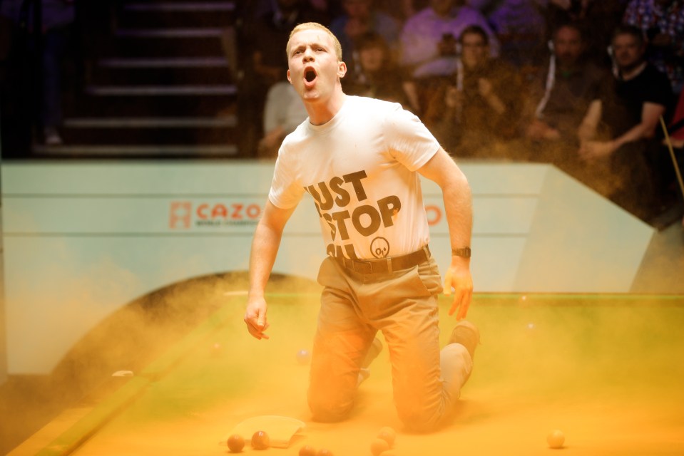 A protester even flung orange powder around to interrupt the snooker at Sheffield's Crucible