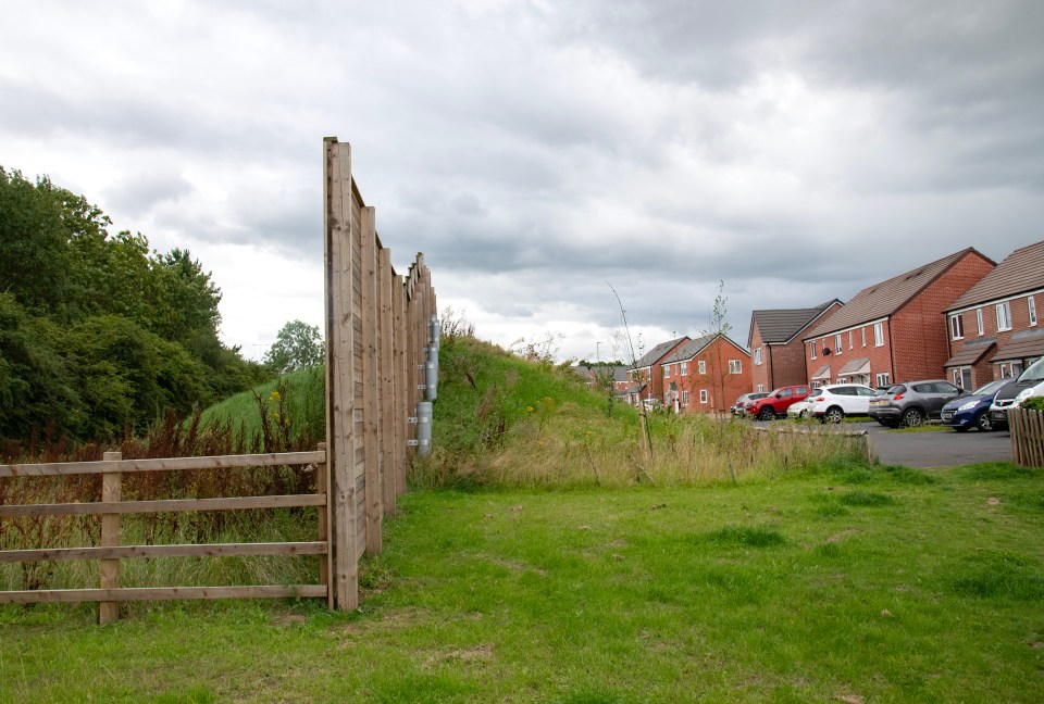 A wooden 'acoustic barrier' blocks out the noise of the motorway