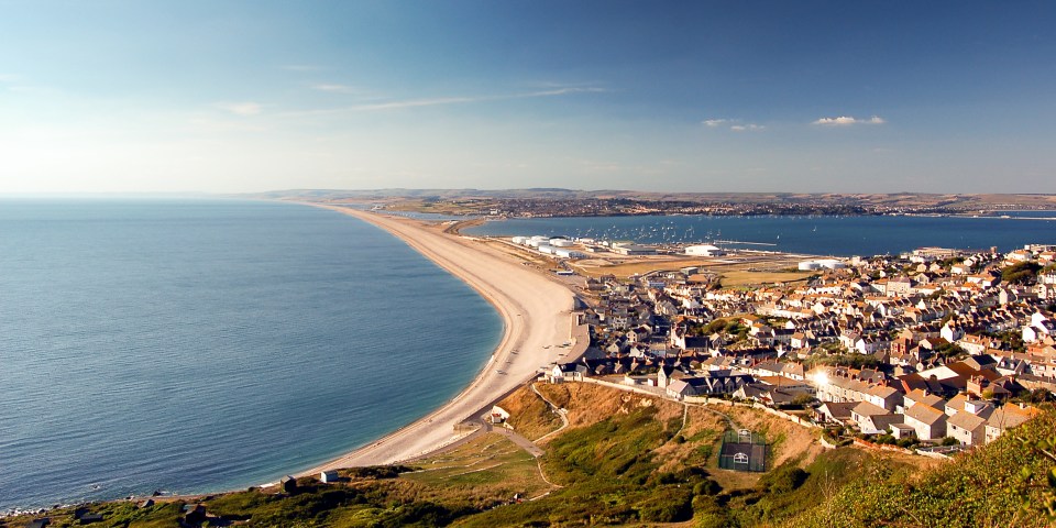 The Bibby Stockholm is sheltered by the vast natural ­barrier of Dorset’s Chesil Beach