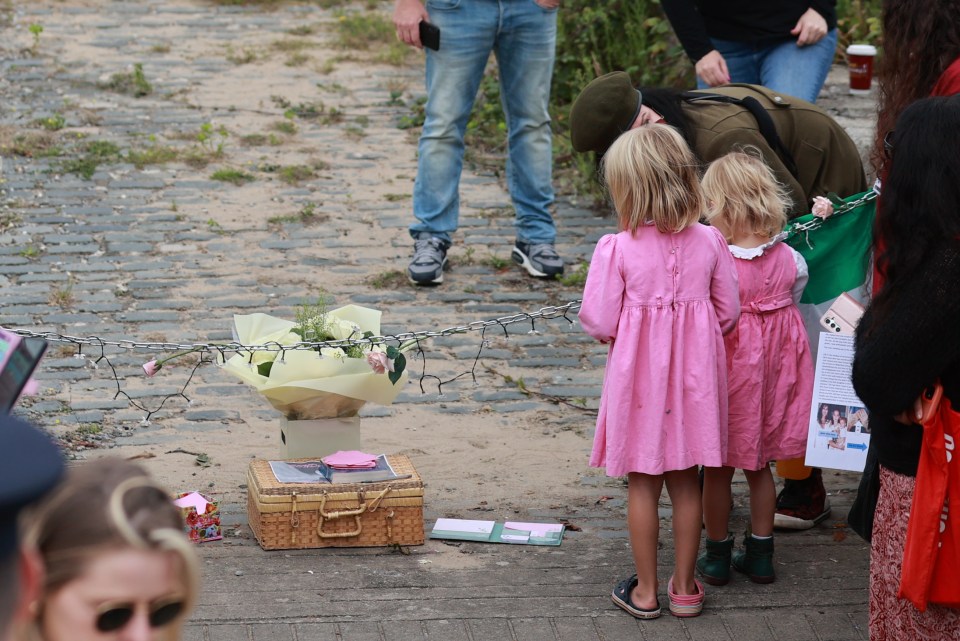 Two young girls pay their respects to the singer