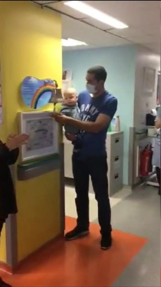 Raphael ringing the bell when he was told he was cancer-free