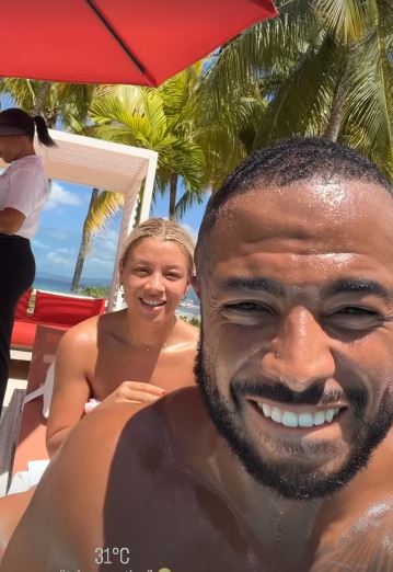 The pair were all smiles relaxing by the pool