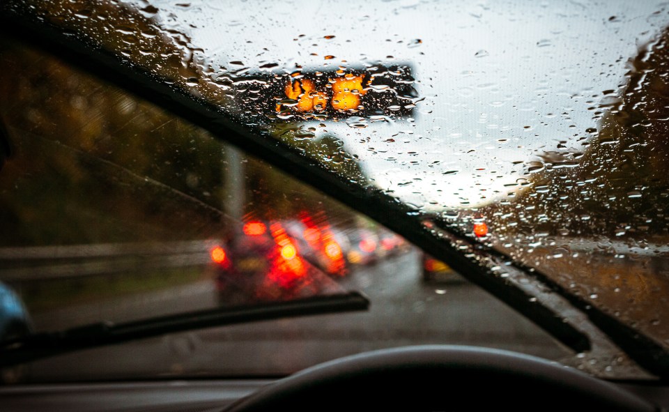 A motorist travels in wet conditions (stock image)