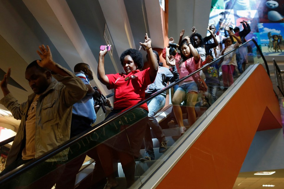 Shoppers flee down escalator in the shopping mall