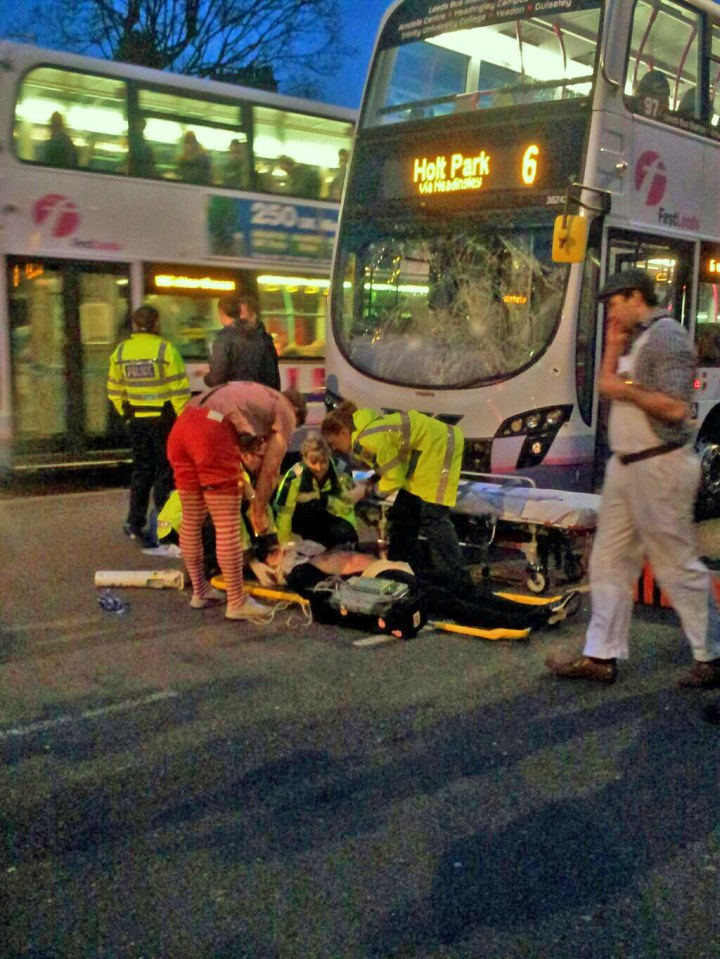 Danny pictured on a stretcher surrounded by paramedics after being hit by a bus on a night out