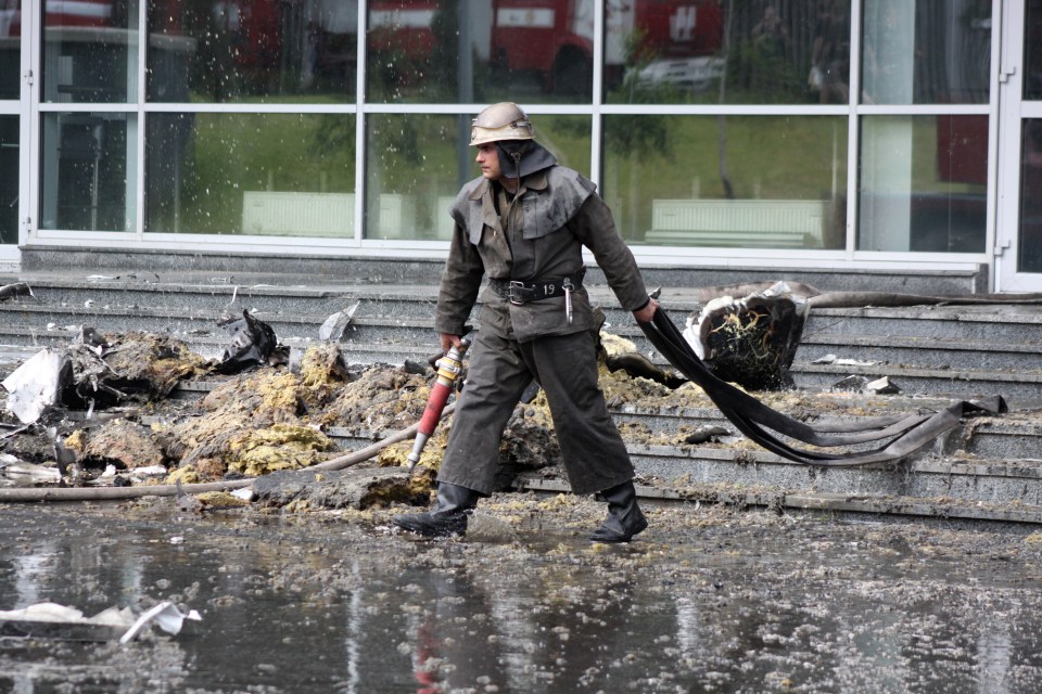 Crew members clear up remains after the stadium was targeted in 2014