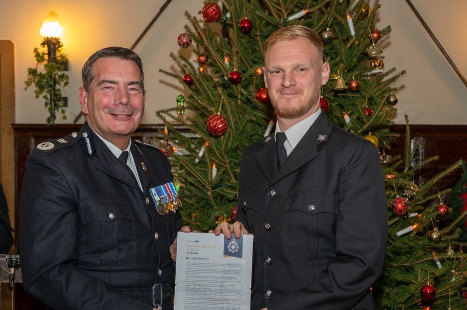 The top cop is seen with medals on his chest at a festive bash