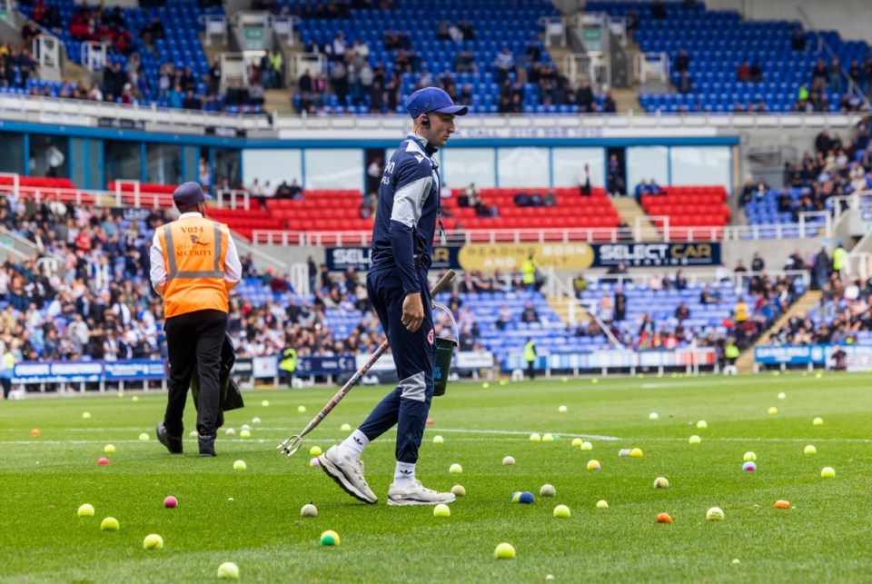 Stewards and ground staff cleared the balls from the pitch