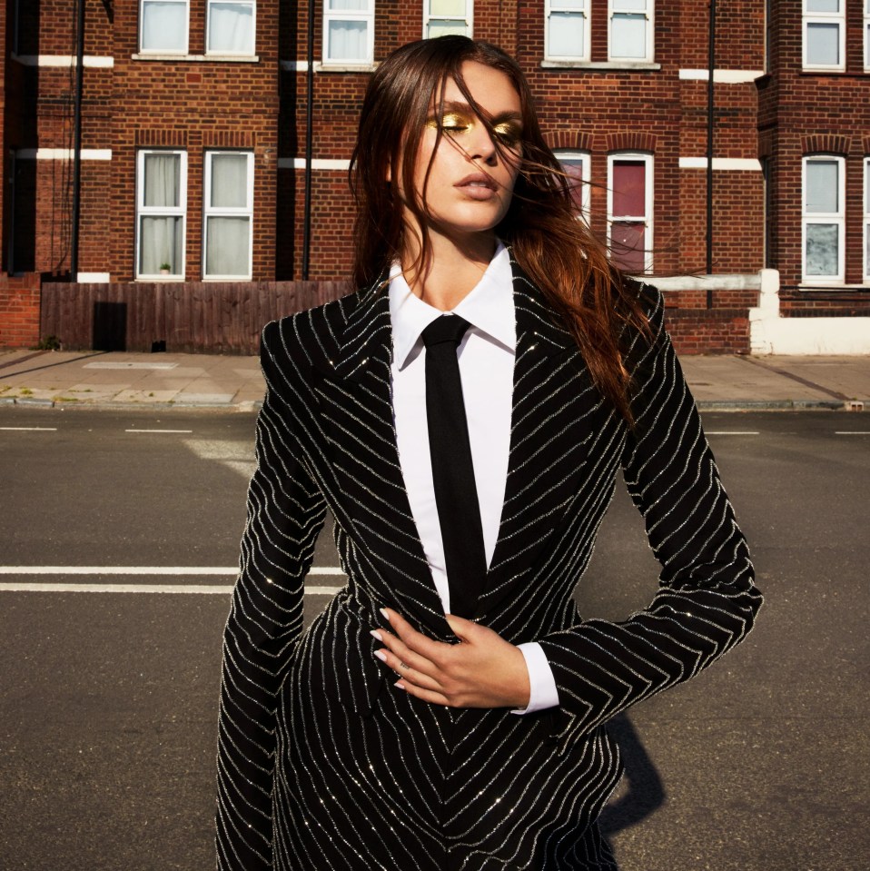 Kaia stikes a pose in this striped blazer complete with black tie