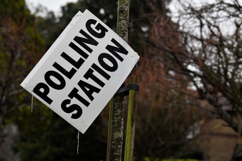 A rain-sodden polling booth sign hangs from a tree in Croydon, south London, as Britain holds a general election on December 12, 2019. (Photo by Ben STANSALL / AFP) (Photo by BEN STANSALL/AFP via Getty Images)