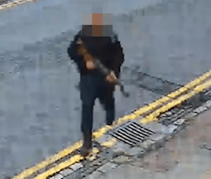 Cops want to track down this man who appears to be carrying a machine gun