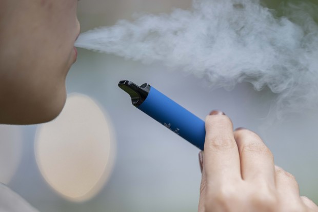 LONDON, ENGLAND - AUGUST 08: A woman smokes vape cigarette in London, England on August 08, 2023. The Local Government Association (LGA), which represents councils in England and Wales, said that 1.3 million disposable cigarettes are thrown away every week. Disposable vape cigarettes create environmental waste and cause fires in garbage trucks. (Photo by Rasid Necati Aslim/Anadolu Agency via Getty Images)