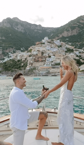 Man proposing to woman on a boat in Italy.