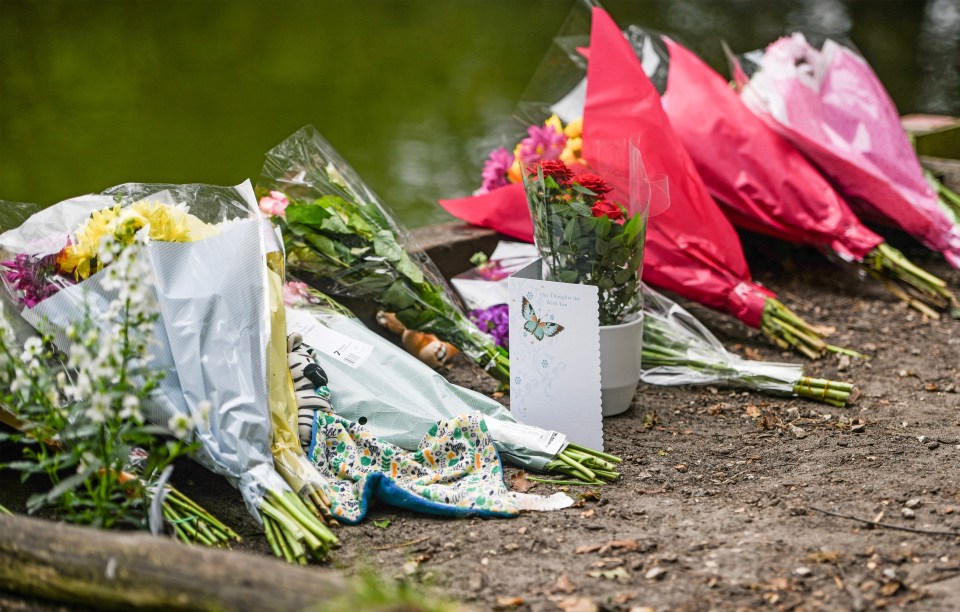 Floral tributes at the edge of the pond