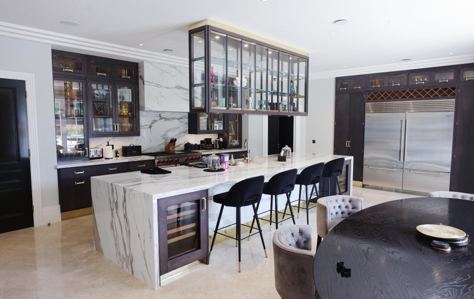 The kitchen comes with a huge island and an enormous American-style fridge freezer