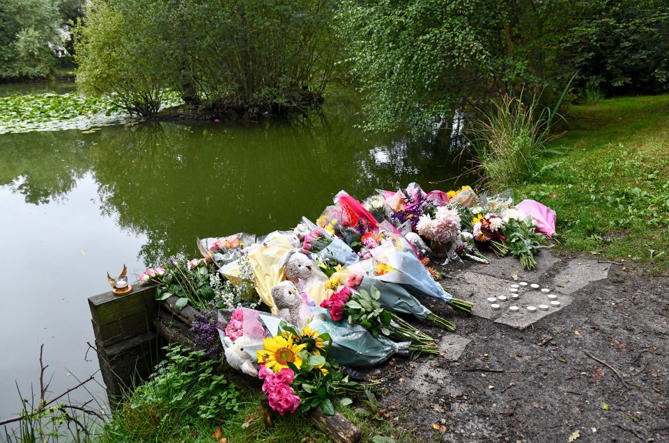 Floral tributes at the edge of the pond