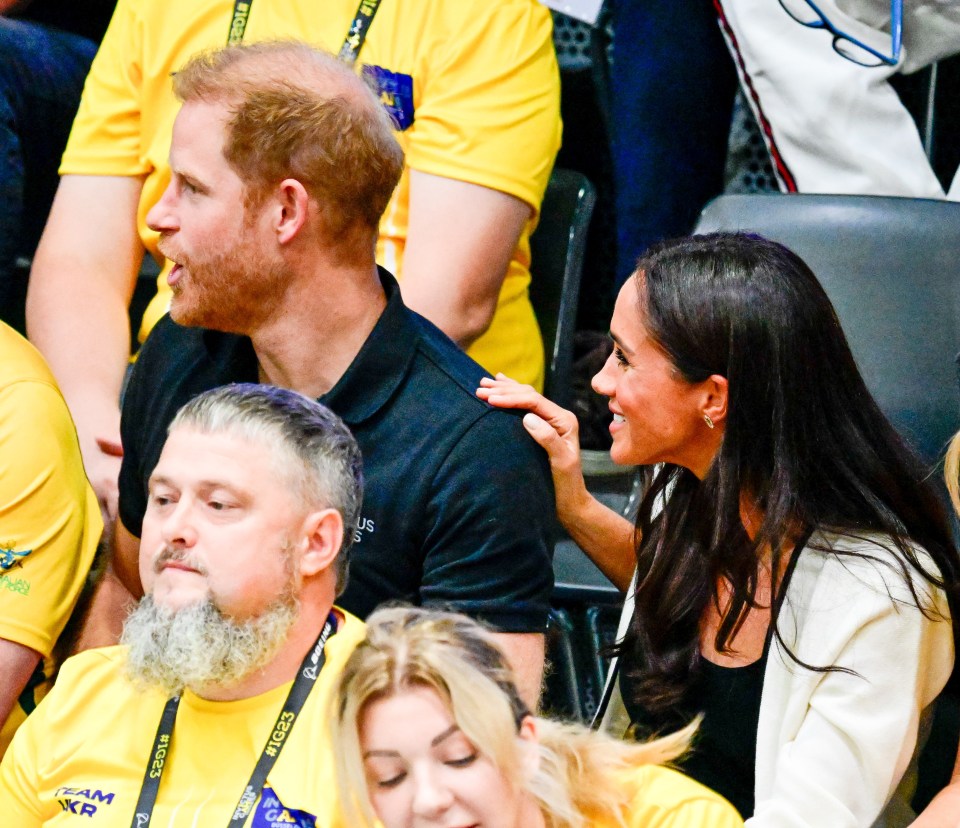 Meghan was seen touching Harry's shoulder once more during the Invictus event