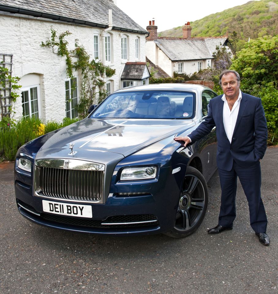 With his Rolls Royce in front of two of his homes near Plymouth