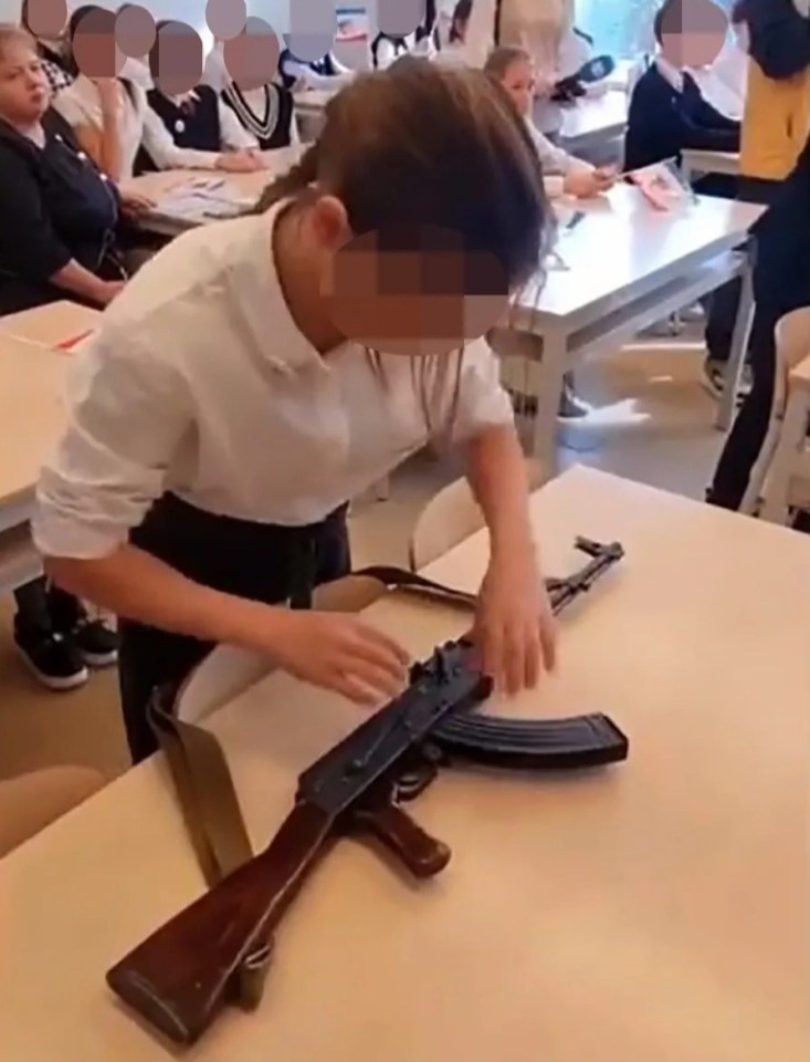 In one school, young children took turns loading rifles