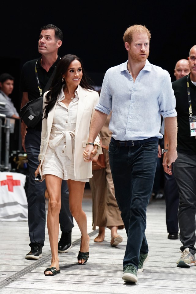 Meg donned a Zara playsuit paired with a Celine blazer and Saint Laurent sandals as she smiled at fans