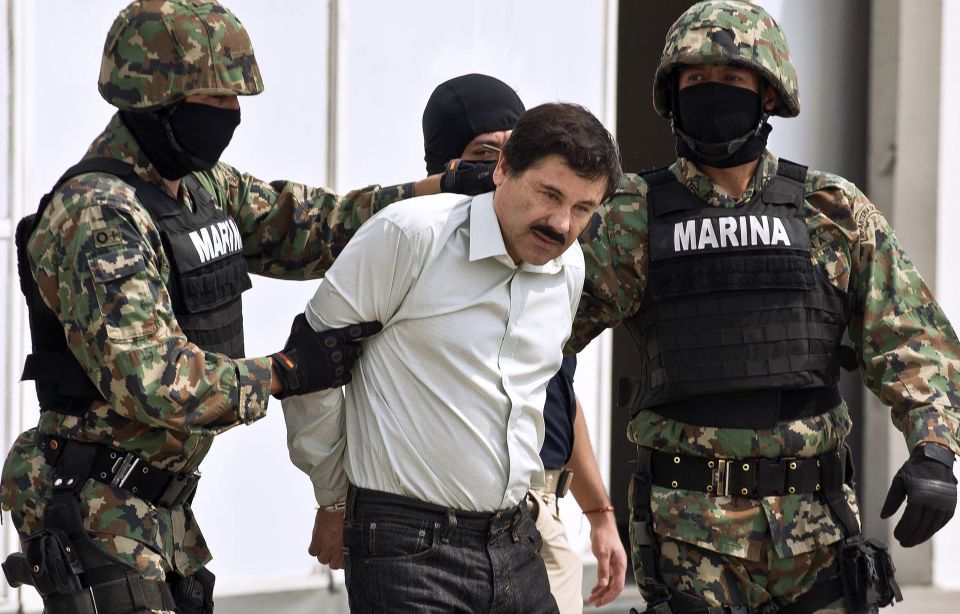 El Chapo is arrested by armed guards before he was sentenced to life in prison