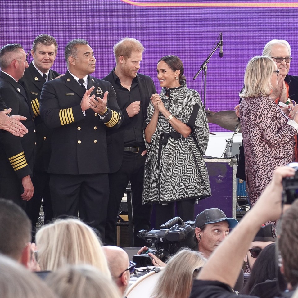 Harry wore black while Meghan donned a sophisticated monochrome jacket with her hair pulled back