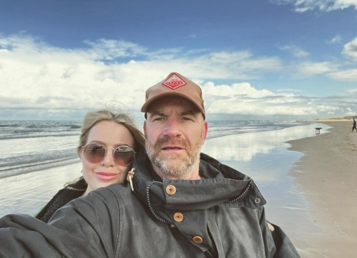 The loved-up pair posed happily on the beach during the break