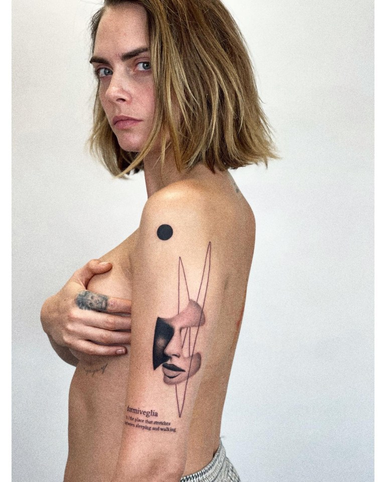 Cara Delevigne posed topless to reveal her latest tattoo