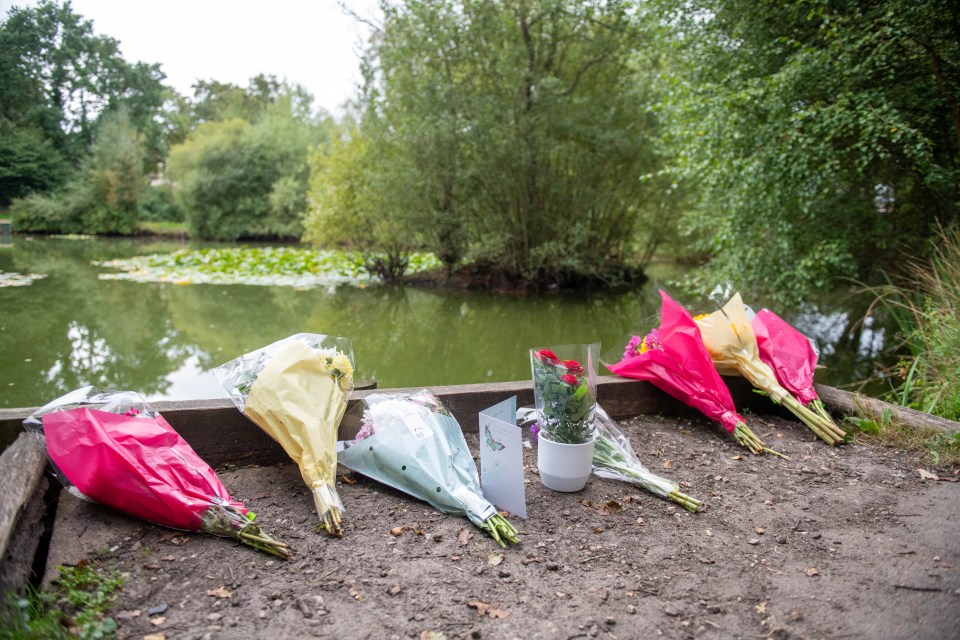 Bunches of flowers were left on the side of the pond