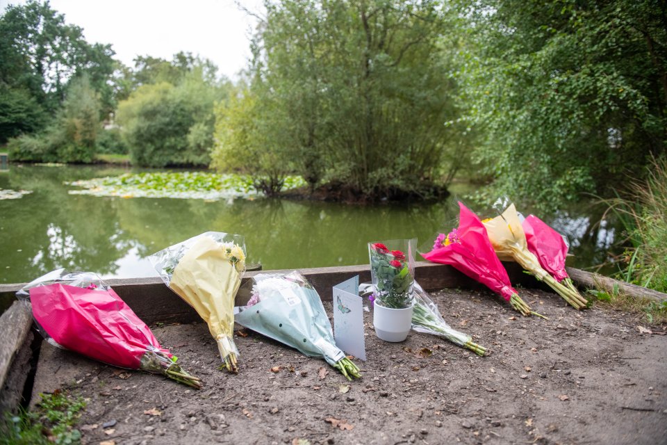 Bunches of flowers were left on the side of the pond on Tuesday