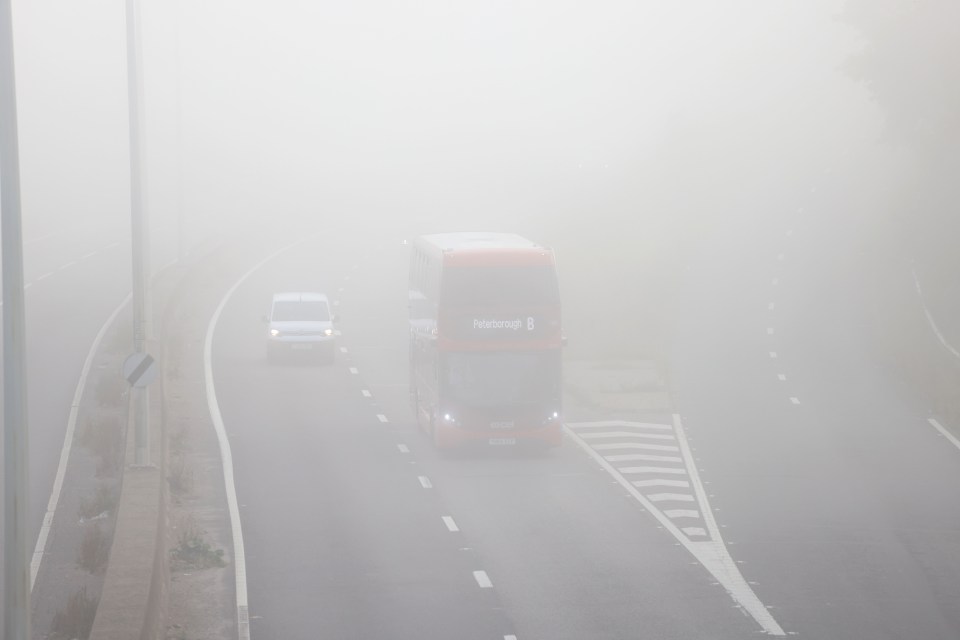 Cars brave the fog near Peterborough this morning