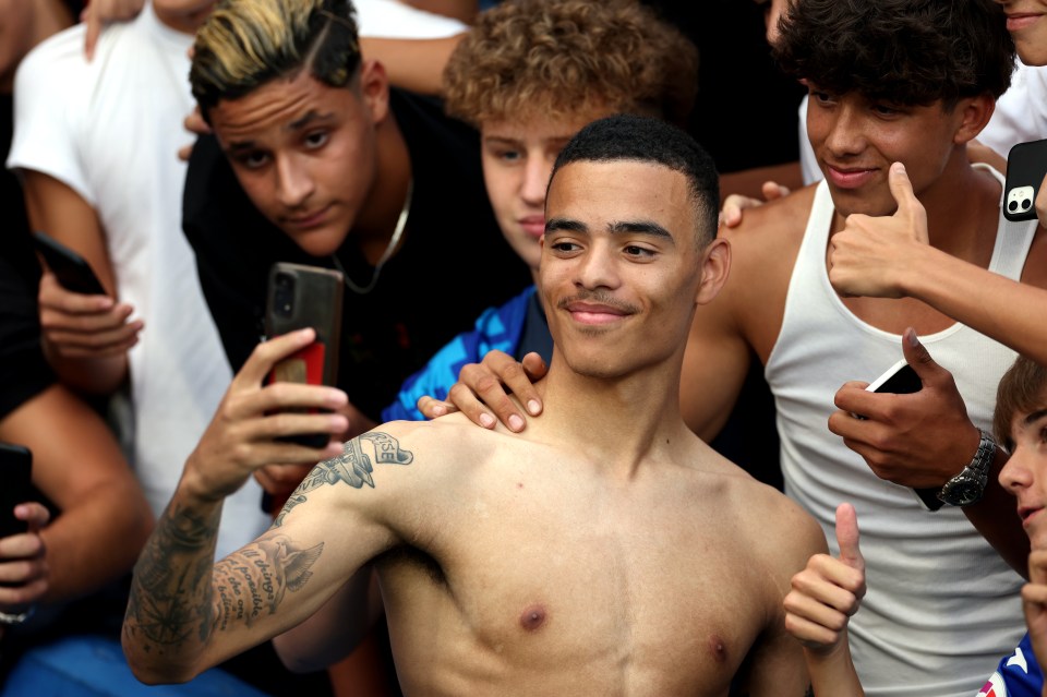 A topless Greenwood took selfies with fans of the Spanish club