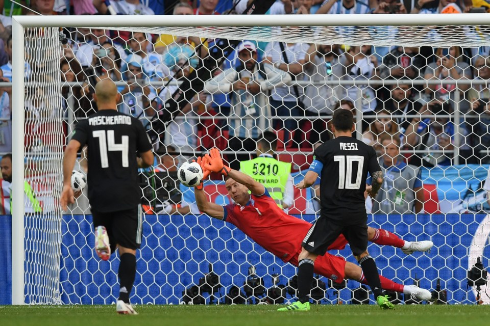 Hannes Halldorsson saves a penalty from Lionel Messi