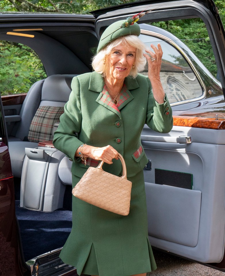 Queen Camilla wore a green skirt suit, which had red tartan detailing