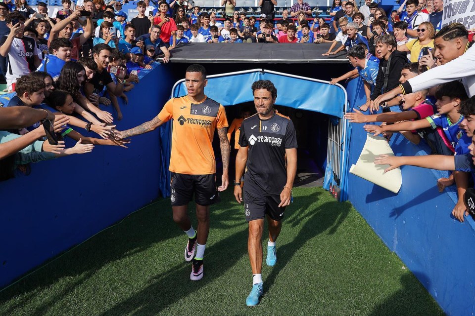 Clamouring fans reach out to high-five the striker as he emerged from a tunnel to be unveiled