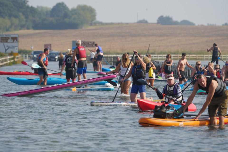 Paddleboarders enjoy the sun near Colchester in Essex