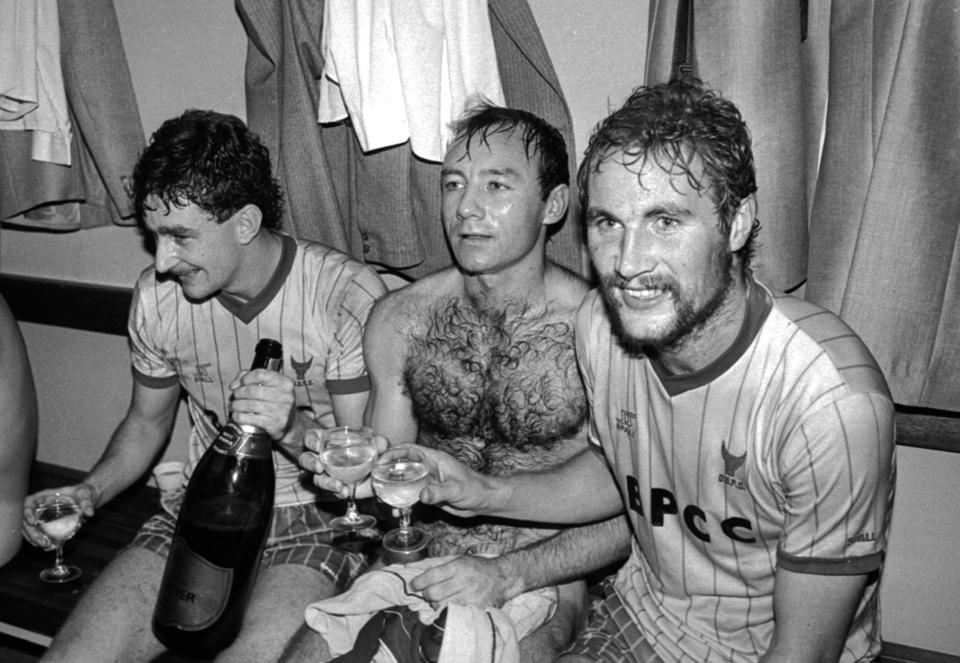 John Aldridge, left, Dave Langan, middle, and Billy Hamilton, right, celebrate in the Manor Ground dressing room