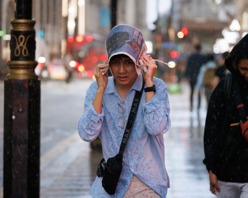 A shopper on London's Oxford Street got a soaking yesterday