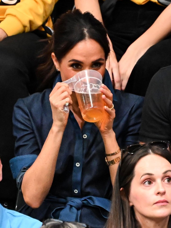 Meghan was spotted sipping down on a beer during the volleyball final