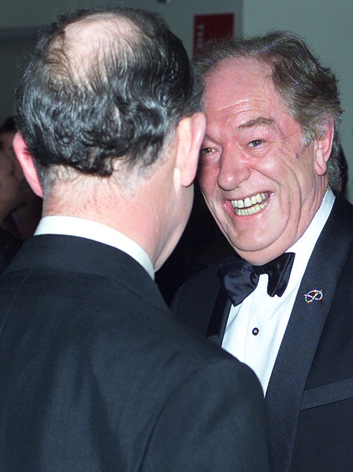 King Charles (then the Prince of Wales) sharing a joke with Gambon in 2002