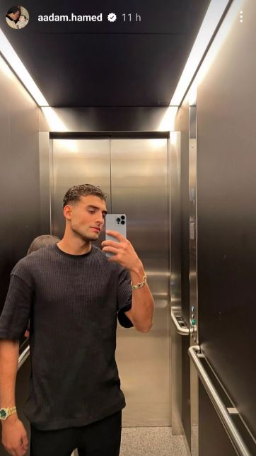 Aadam shared a mirror selfie too, which revealed a brunette woman behind him