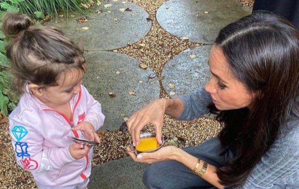 Another snap of Meghan showed her sharing a sweet moment with a young girl