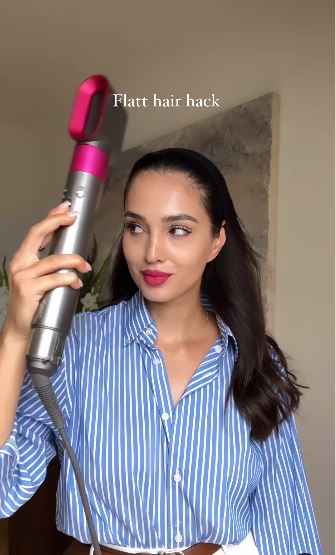 The influencer began by combing her hair back, before securing it in place with a headband and blasting it with her dryer