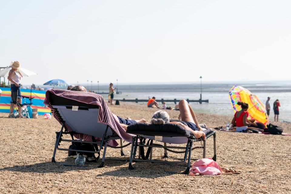 Sunbathers on Southend beach make the most of the hot weather