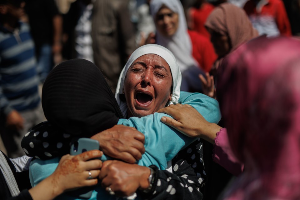 A woman grieves after the devastating 6.8 magnitude quake